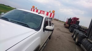escort vehicle keeping a heavy haul load safe through manitoba